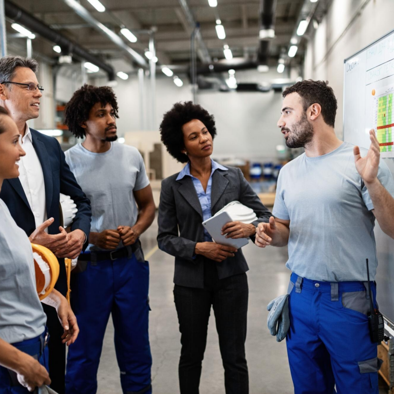 Team discussing project in warehouse